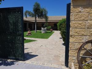 an open gate to a house with a yard at Residencial La Teja in Zahora