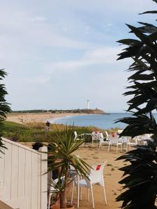 a group of chairs sitting on the beach at Residencial La Teja in Zahora