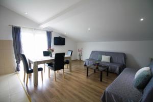 a living room with a table and a couch at Sebi Apartment 300 m from beach in Rovinj