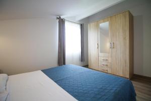 a bedroom with a bed and a dresser and a window at Sebi Apartment 300 m from beach in Rovinj