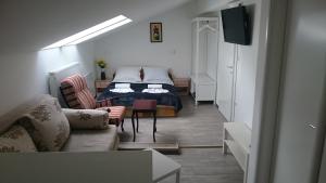 Guest House Villa Herbarium في سلافونسكي برود: غرفة معيشة مع سرير وأريكة