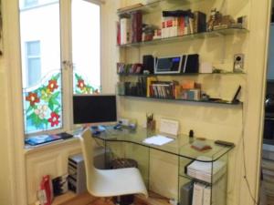 a desk with a computer and a chair in a room at Apartment Alster in Hamburg