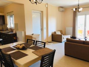 a kitchen and living room with a table and chairs at Renting House GALINI in Plakias