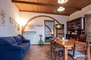 uma sala de estar com uma mesa e um sofá azul em Agriturismo Il Poderuccio em Castiglione dʼOrcia