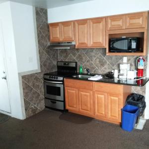 a kitchen with a stove and a microwave at Tide Winds Motel in Wildwood