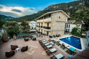 a large building with a swimming pool and a resort at Seyir Beach Hotel in Oludeniz