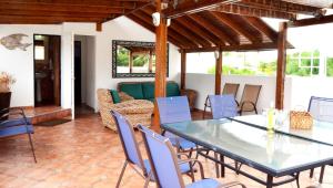 a patio with a table and chairs and a couch at Casa Almendro in San Juan
