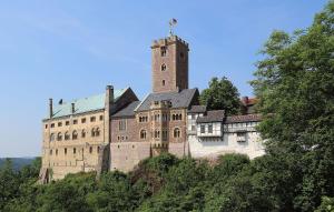 a large castle with a tower on top of a hill at Gaestehaus Remde in Erfurt