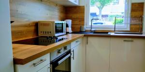 a kitchen with a counter top with a microwave at Appart'HomeCity - Rouen Grand Voile in Rouen