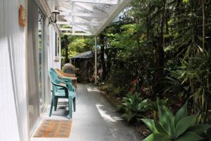 a porch with a green chair on a house at Country Goose in Volcano