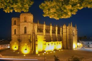 a large building with lights on it at night at Ferrinho in Guarda