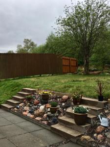 a garden with rocks and potted plants in a yard at NUMBER 7 in Kyleakin