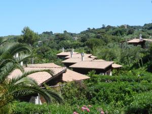 a group of houses with tiled roofs on a hill at Tenuta Molino di Mare in Rodi Garganico