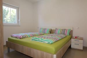 Ein Bett oder Betten in einem Zimmer der Unterkunft Apartments Maric-Hlapa