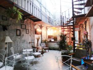 a room with chairs and tables in a building at Sennong Homestay in Tainan