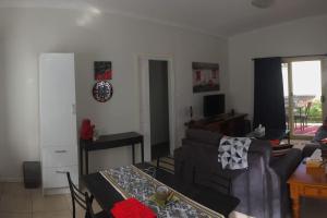 a living room with a couch and a table at Self-contained Private 2 Bedroom Apartment in Macgregor