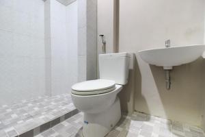 a bathroom with a toilet and a sink at RedDoorz near Solo Balapan Station 2 in Solo