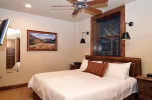 a bedroom with a bed and a ceiling fan at Innsbruck Aspen Deluxe One-Bedroom Garden Residence 2, Located on Main Street in Aspen