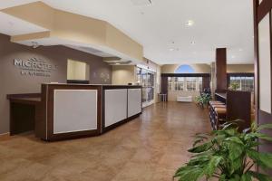 a lobby of a hotel with a reception desk at Microtel Inn & Suites-Sayre, PA in Sayre