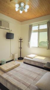 Postel nebo postele na pokoji v ubytování Dongyin Homestay連江縣民宿054號