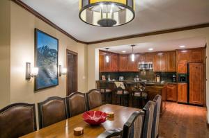 a dining room and kitchen with a table and chairs at The Ritz-Carlton Club, 3 Bedroom Residence 8304, Ski-in & Ski-out Resort in Aspen Highlands in Aspen