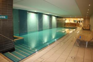 a large swimming pool in a building at Beachside Luxury Apartments One & Two Bedroom in Beachfront Oaks Pier Building in Glenelg