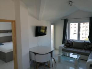 a living room with a couch and a table at Apartments Olga in Tivat