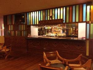 a bar with chairs and a bar counter with a bar at The Halfway Inn in Guerrero Negro