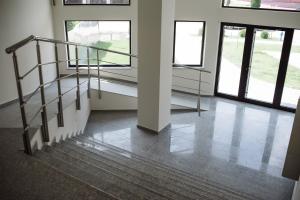 an empty room with stairs and windows in a building at Jacuzzi Room in Subotica