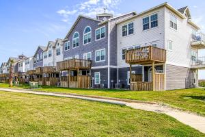 a large apartment building with balconies and a yard at Pathway 14838 in Padre Island