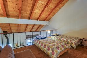 two beds in a room with wooden ceilings at 2 Bed 2 Bath Apartment in Carnelian Bay in Carnelian Bay +40 photos
