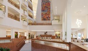 a lobby of a hospital with stairs and a painting on the wall at St Raphael Resort in Limassol