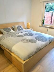 sypialnia z dużym łóżkiem z drewnianą ramą w obiekcie Duinenblik 2 w mieście Nieuwpoort