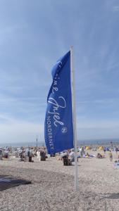 a blue flag on the beach with people on the beach at Villa Christina in Norderney
