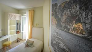 a living room with a picture of a mountain at Chez Laurette in Saint-Remèze