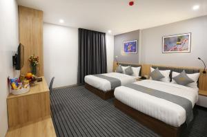 Tempat tidur dalam kamar di Davue Hotel by THG
