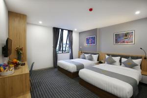 Tempat tidur dalam kamar di Davue Hotel by THG