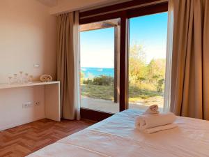 En eller flere senge i et værelse på Villa Tanaquilla