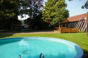 a swimming pool in the yard of a house at Das Haus mit der roten Telefonzelle in Apen