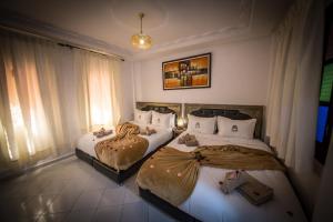 Postel nebo postele na pokoji v ubytování Riad Challa Hotel & Spa