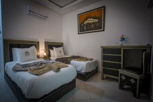 Postel nebo postele na pokoji v ubytování Riad Challa Hotel & Spa