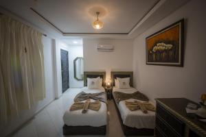 Postel nebo postele na pokoji v ubytování Riad Challa Hotel & Spa