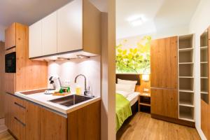 a kitchen with a sink and a bed in a room at INhouse - Wohnen auf Zeit in Ingolstadt