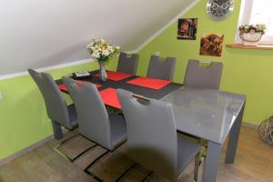 a dining room with a glass table and chairs at Apartament u Robsona in Wilkasy