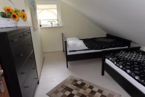 a small room with two beds and a mirror at Apartament u Robsona in Wilkasy