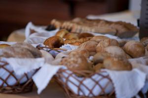 a bunch of pastries in baskets on a table at Ocean Gardens in Funchal
