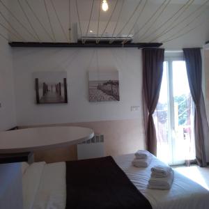 a bedroom with a bed and a table with towels at Villa Azur Cap d'Ail in Cap d'Ail