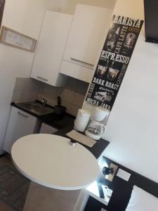 a kitchen with a white table and a white stool at Villa Azur Cap d'Ail in Cap d'Ail