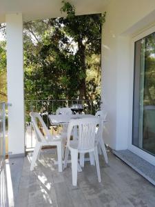 a white table and chairs on a patio at in campagna da Nino in Olbia