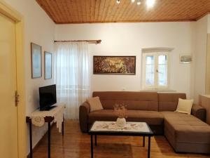 a living room with a couch and a table at Lefki's house in Drymon
